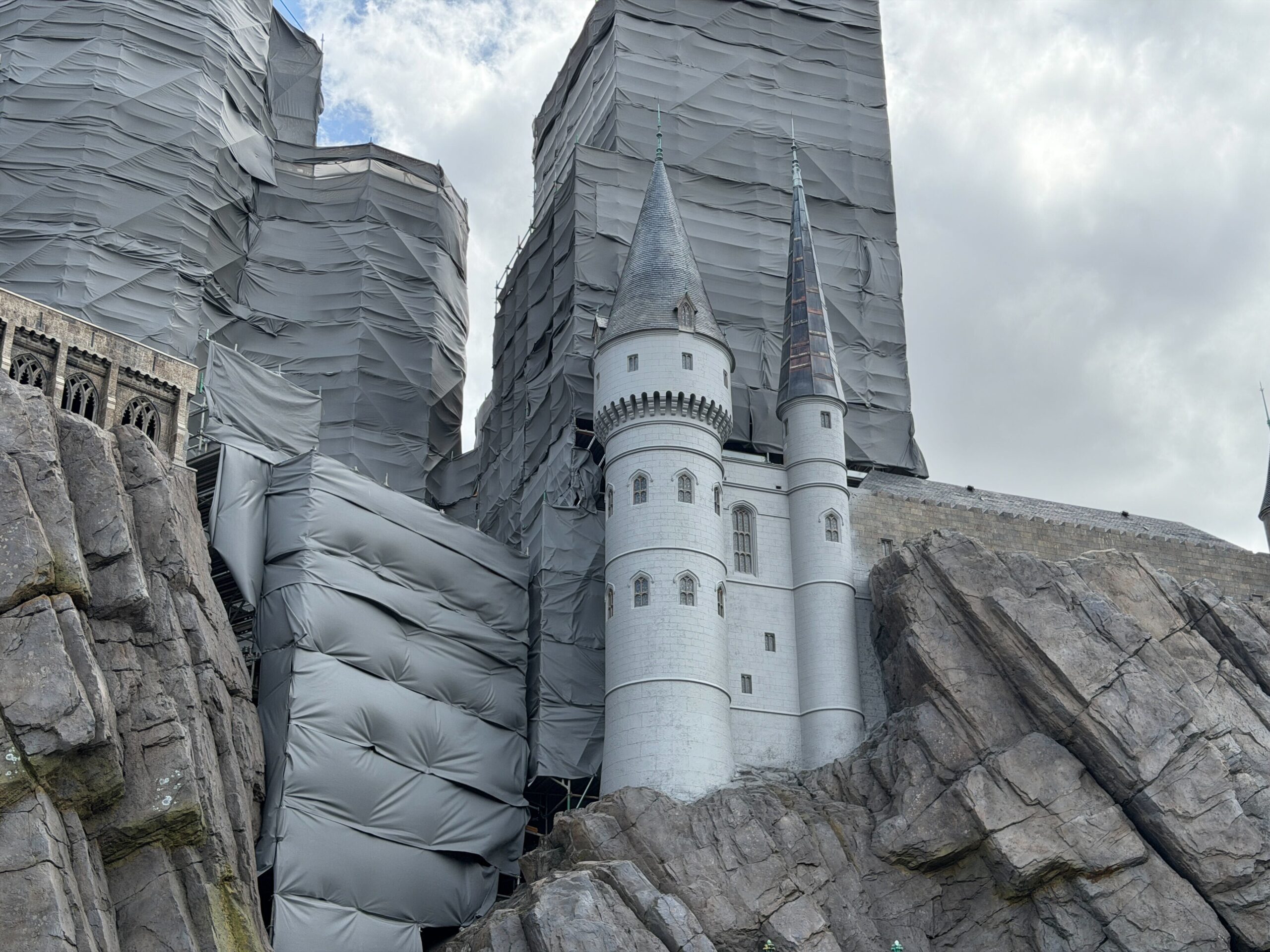 Hogwarts Castle towers showing gray primer coating during refurbishment