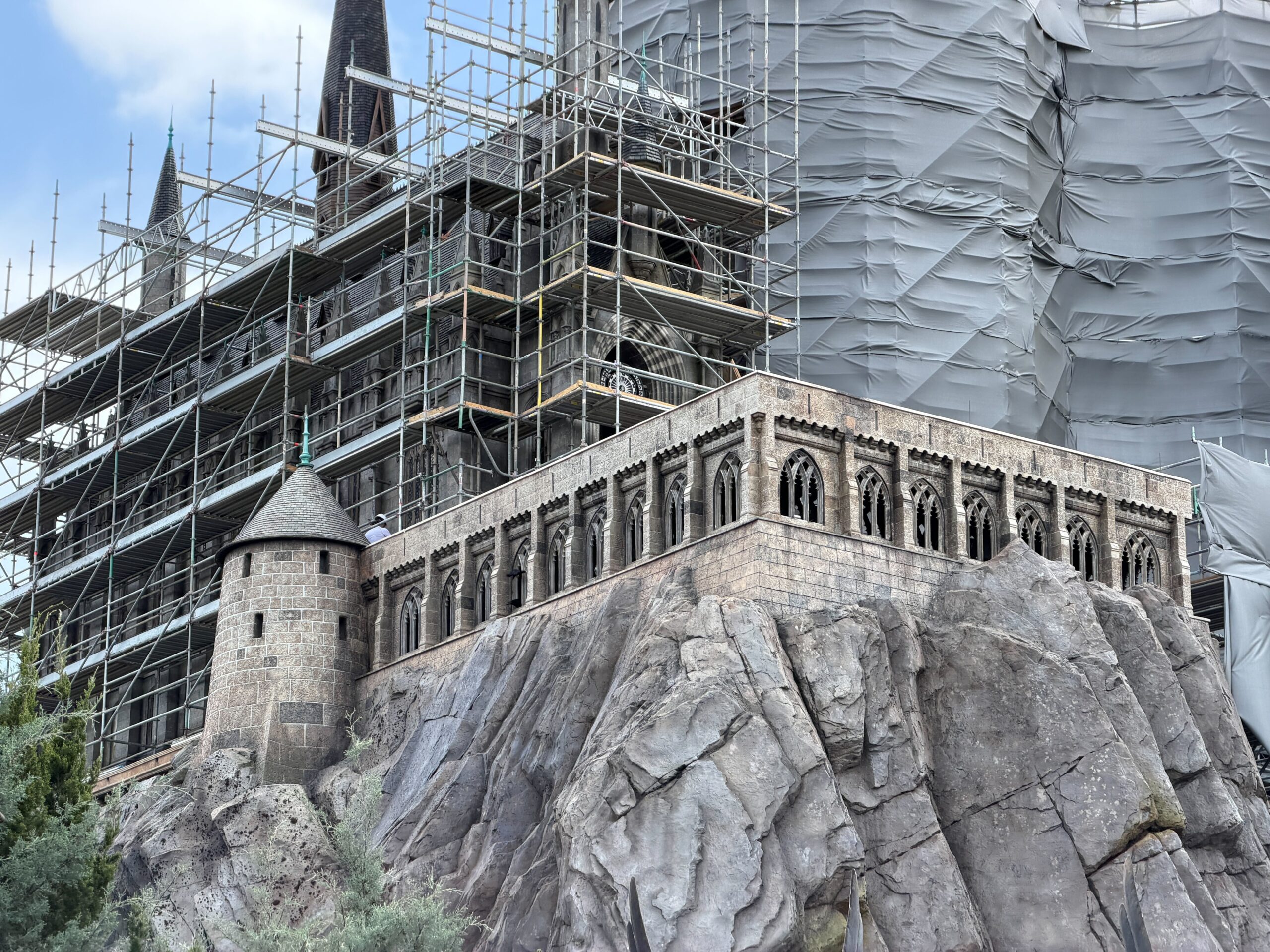 Close-up view of castle wall showing transition between gray primer and original brown finish